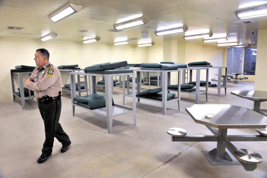 Jail Commander Dan Penland walks through the Jackson County Jail on June 28, 2016 in Medford, Ore. Police and prosecutors are working to keep domestic violence perpetrators locked up longer if a questionnaire turns up red flags.