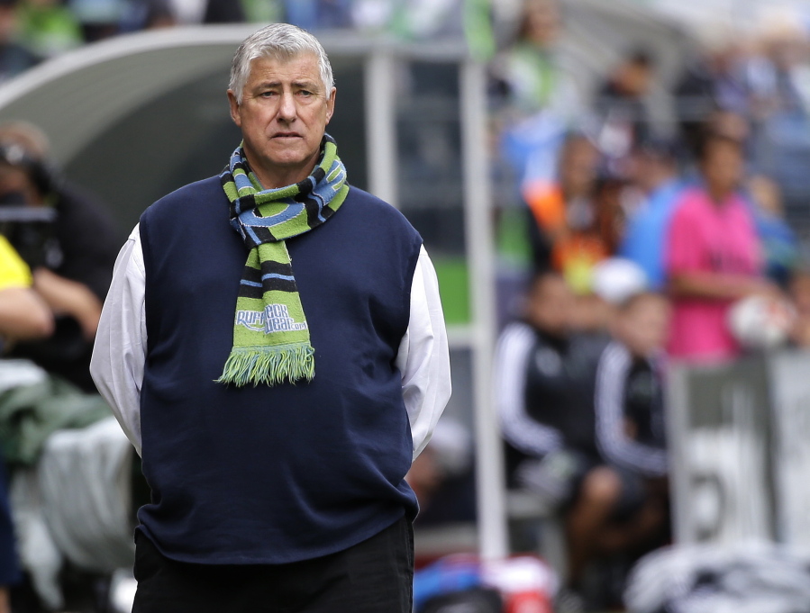 File-This Aug. 30, 2015, file photo shows Seattle Sounders head coach Sigi Schmid standing on the sideline during an MLS soccer match against the Portland Timbers in Seattle.  The Seattle Sounders and Schmid are parting ways after eight years. The team announced Tuesday, July 26, 2016, that Schmid???s run as the only coach in the franchise???s MLS era is coming to an end. Longtime Sounders assistant Brian Schmetzer is immediately taking over as interim head coach.(AP Photo/Ted S.