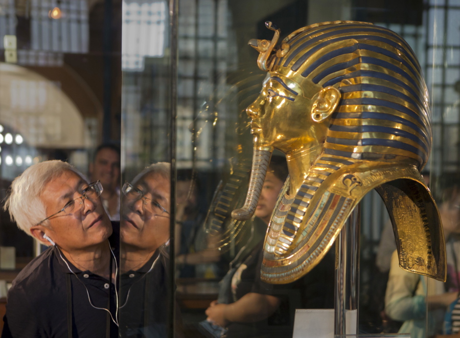 A visitor looks at the gold mask of King Tutankhamun on Thursday at the Egyptian museum in Cairo.