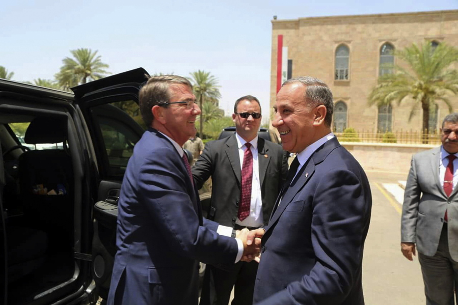 Visiting U.S. Defense Secretary Ash Carter, left, shakes hands with Iraqi Defense Minister Khaled al-Obeidi at the Ministry of Defense, Baghdad, Iraq, on Monday.