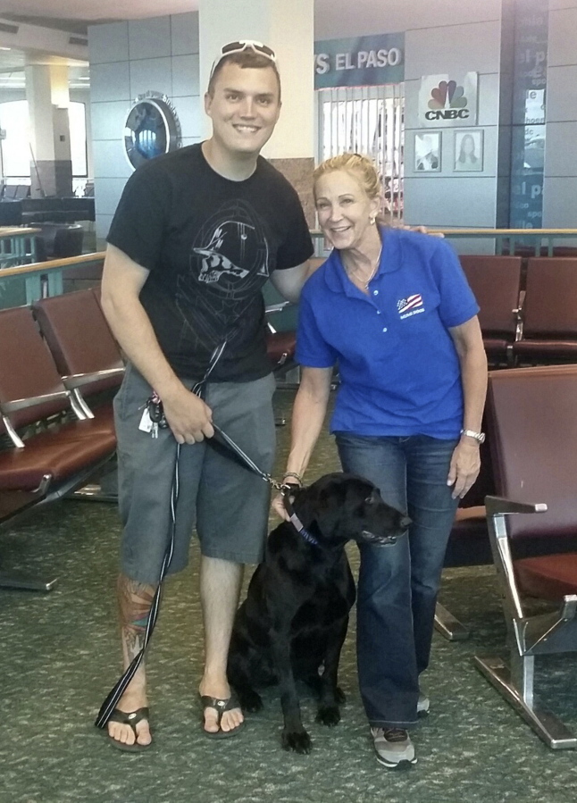 Molli Oliver, a flight attendant with United Airlines, reunites Army Staff Sgt. Derrek Green and a black Lab named Zeva in El Paso, Texas.