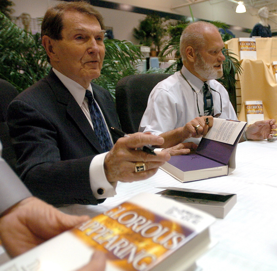 Co-authors Tim Lahaye, left, and Jerry B. Jenkins sign copies of their newest book &quot;Glorious Appearing&quot; in 2004 in Bossier City, La. LaHaye died Monday.
