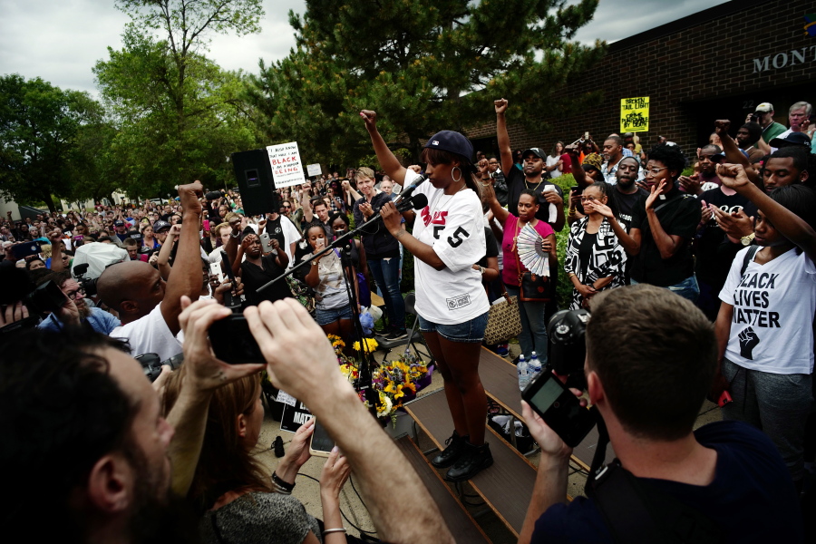 Diamond Reynolds, center, addresses the crowd at JJ Hill Montessori Magnet School where mourners held a vigil Thursday in St,Paul, Minn., in response to the shooting death of Philando Castile by police.