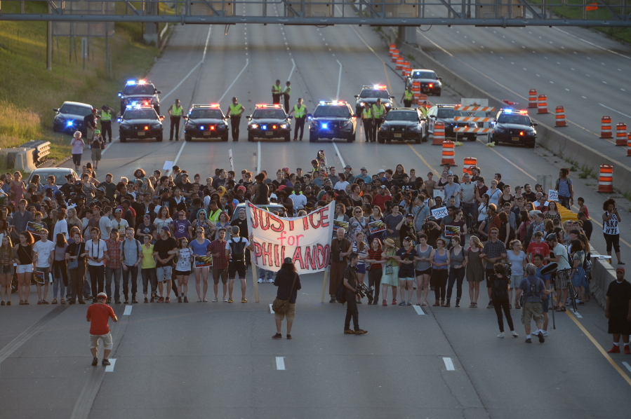 Marchers block part of Interstate 94 in St. Paul, Minn., Saturday, July 9, 2016, during a protest sparked by the recent police killings of black men in Minnesota and Louisiana.