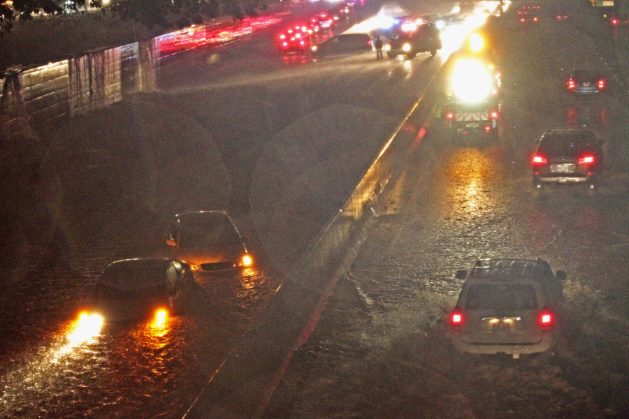 Two automobiles are submerged in flood water Sunday on the westbound lanes of the H-1 Freeway, as heavy rain falls during tropical storm Darby in Honolulu. The first storm of the hurricane season to impact Hawaii sent the islands&#039; residents into hurried preparation mode, but the state got through the weekend without seeing major damage as the storm was downgraded, officials said Monday.