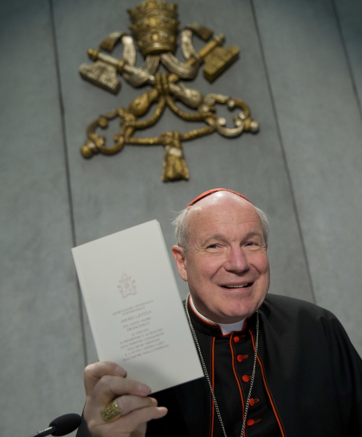 Cardinal Christoph Schoenborn holds a copy of the post-synodal apostolic exhortation &quot;Amoris Laetitia&quot; (&quot;The Joy of Love&quot;) during a press conference at the Vatican.