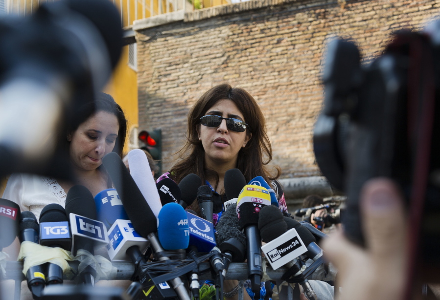 Italian communications expert Francesca Chaouqui talks to journalists on Thursday after a Vatican court convicted her and a Vatican monsignor for having conspired to pass documents to two Italian journalist. The court also declared it had no jurisdiction to prosecute two journalists for having published the confidential information and asserted the Vatican guarantees the freedom of the press.