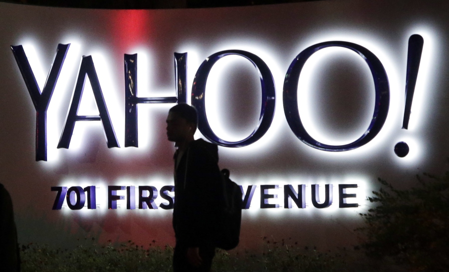 A person walks in front of a Yahoo sign at the company&#039;s headquarters in Sunnyvale, Calif. on Nov. 5, 2014. Verizon bought Yahoo in a sale announced Monday, July 25, 2016.