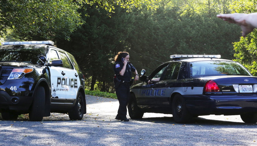 Mukilteo police monitor the access point to the crime scene from a block away, after a shooting in Mukilteo on Saturday.  A suspect was apprehended three counties away, said Officer Myron Travis of the Mukilteo Police Department.