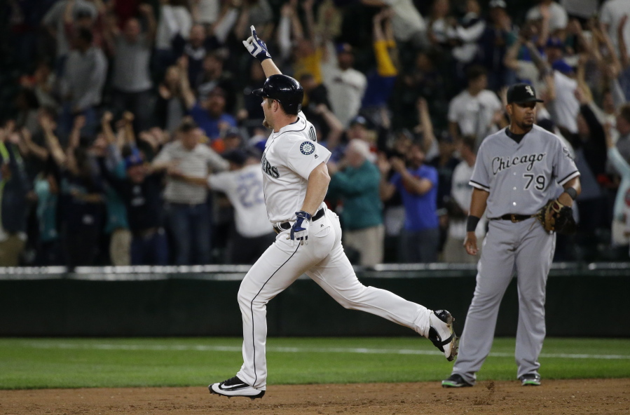 Seattle Mariners&#039; Adam Lind, left, rounds the bases past Chicago White Sox first baseman Jose Abreu, right, after Lind hit a three-run walk-off home run in the ninth inning of a baseball game, Monday, July 18, 2016, in Seattle. The Mariners beat the White Sox 4-3. (AP Photo/Ted S.
