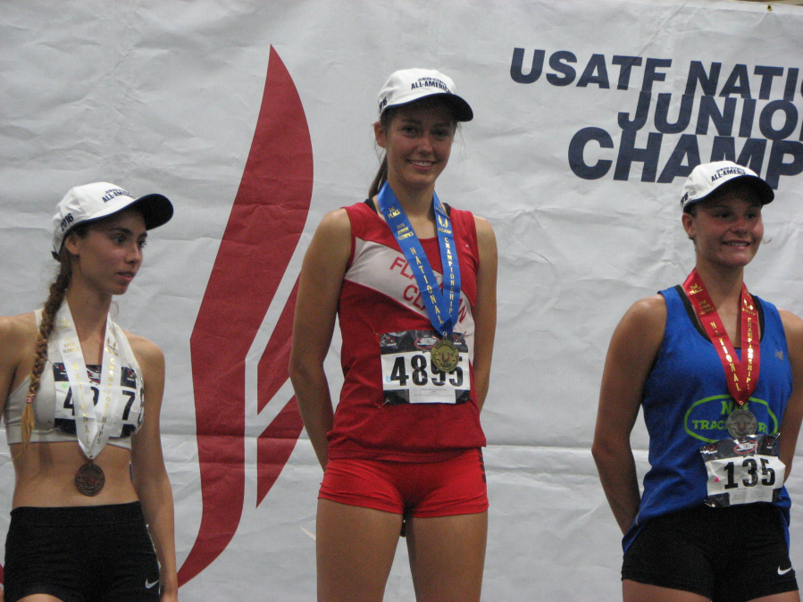 Jenna Melanson, center, stands atop the awards podium after winning the steeplechase at the USTAF Junior Olympics in Sacramento, Calif.