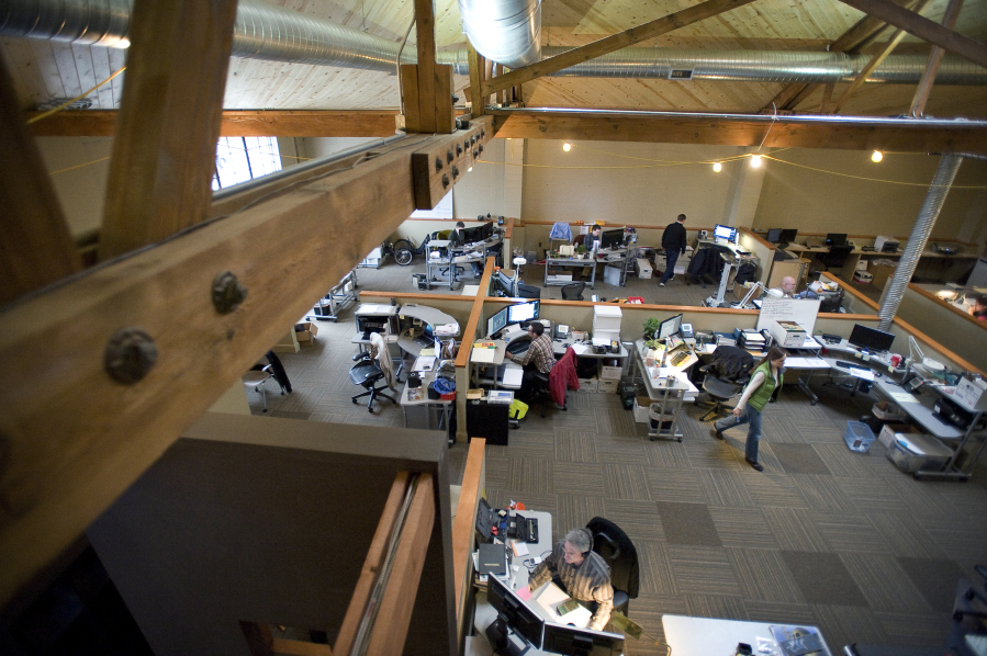 Employees get to work inside the Sigma Design office in a converted auto repair shop in 2011.