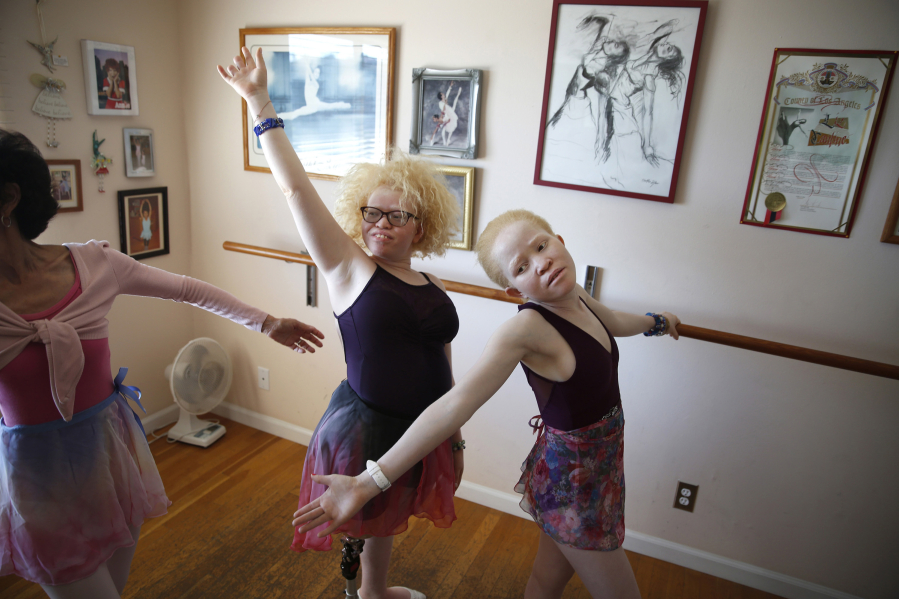 Bibiana Mashamba, left, and her younger sister Tindi take a ballet lesson with Liz Cantine, far left, in October in Palos Verdes, Calif.