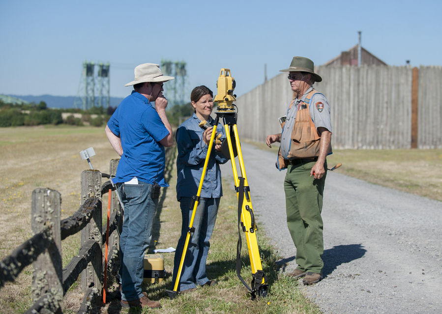 University of Oregon graduate Tim Askin, from left, and University of Idaho grad student Idah Whisenant use surveying equipment with archaeologist Doug Wilson during a July archaeology field-school session at Fort Vancouver National Historic Site.