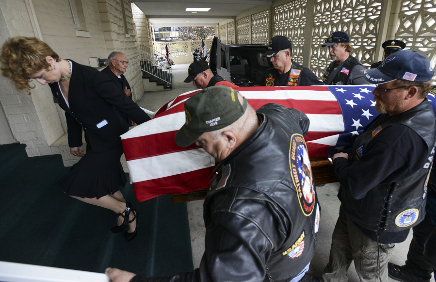 Led by funeral director Leigh Mullen, left, Patriot Guard Riders carry the remains of Army Pfc. William Butz into the Vancouver Funeral Chapel on Tuesday. People can pay their respects today and Thursday from 9 a.m. to 4 p.m.