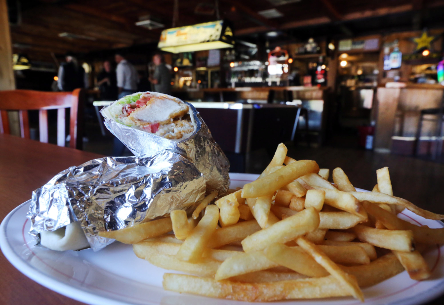 A chicken-bacon wrap with fries is served Aug. 6 at the Spot Bar &amp; Grill in Vancouver.