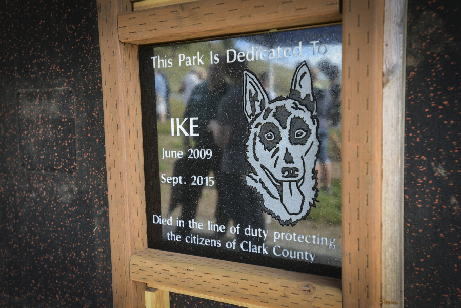 A plaque remembering Vancouver police dog Ike, who died in the line of duty last year, is displayed at the newly named Ike Memorial Dog Park in Hazel Dell, formerly known as Ross Dog Park. The dedication ceremony Monday was attended by K-9 teams from across Clark County, community members and their dogs.