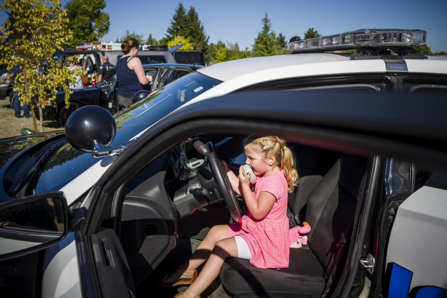 Four-year-old Kinley Goertler from Camas gets hands-on with the inside of a Vancouver Police Department patrol car during a recruitment event for girls curious about careers in law enforcement last year at the Vancouver Police East Precinct.