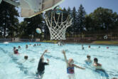 Alex Erickson, 8, of Camas, left, joins Caylee Wilcox, 9, of Vancouver as they take aim at the basketball hoop Aug. 12, 2016, at Camas Municipal Pool.