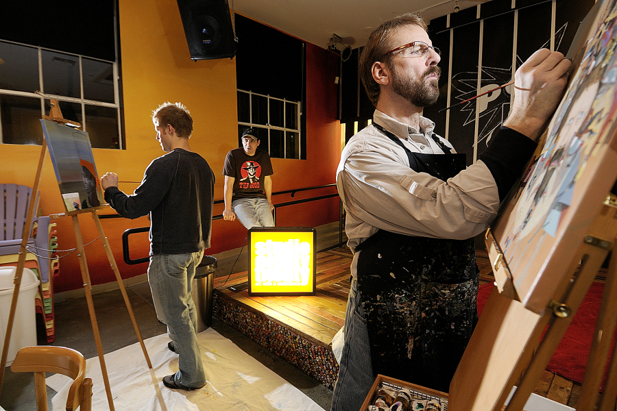 John Wyckoff, right, paints with his son, Isaiah, in 2010 during an Art With a Conscience event at the former Pop Culture club on upper Main Street. That&#039;s owner Dan Wyatt -- now the owner of Kiggins Theatre -- in between them.