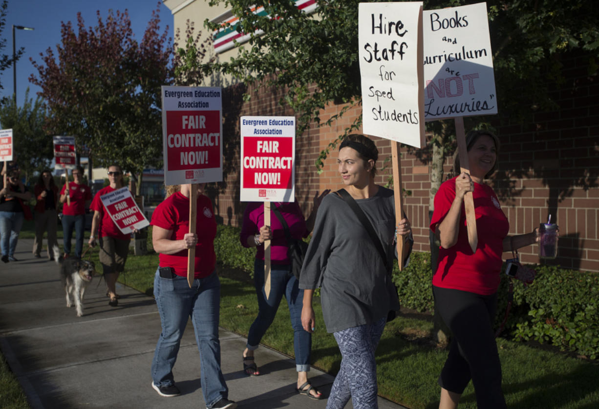 Cecilia Magistrale, in gray, joins her mom, Evergreen Public Schools teacher Angela Magistrale, right, and other pickets Aug. 19 in Southeast Vancouver. The teachers union and the school district are in the midst of contentious contract negotiations.