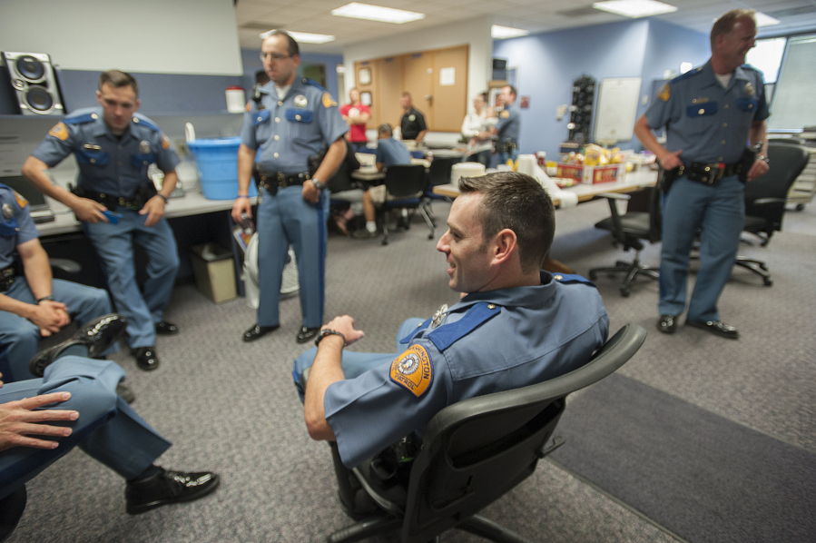Trooper Jeff Wallace, center, chats with other members of the department as they gather for a barbecue Monday at Washington State Patrol District 5 Headquarters. Wallace is one of six troopers who transferred to the area this week, marking the first time in nearly four years the region has been fully staffed.