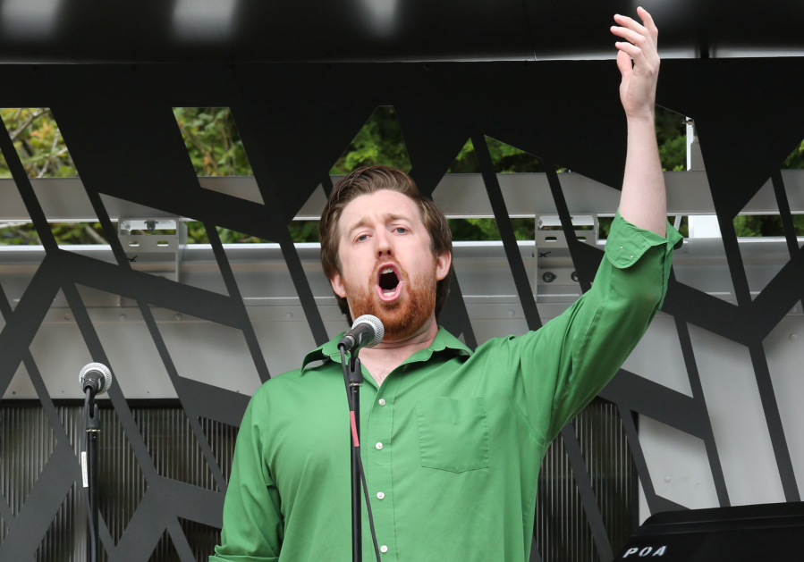 Zachary Lenox of the Portland Opera sings &quot;Toreador&quot; from &quot;Carmen&quot; during an Opera a la Cart performance at the Vancouver Farmers Market on Saturday. Opera a la Cart, a mobile venue, is a play on the Pacific Northwest&#039;s food truck scene.