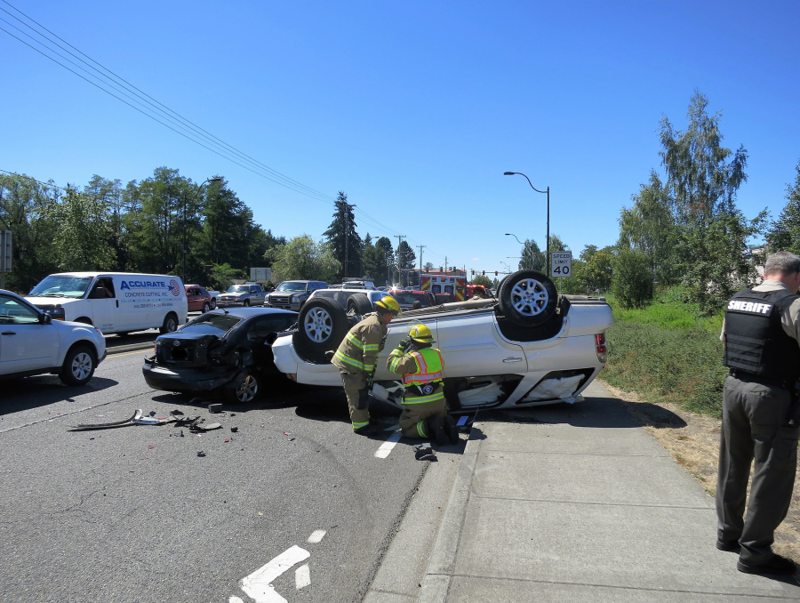 Emergency crews respond to a four-vehicle crash Monday at state Highway 503 and Main Street in Battle Ground.