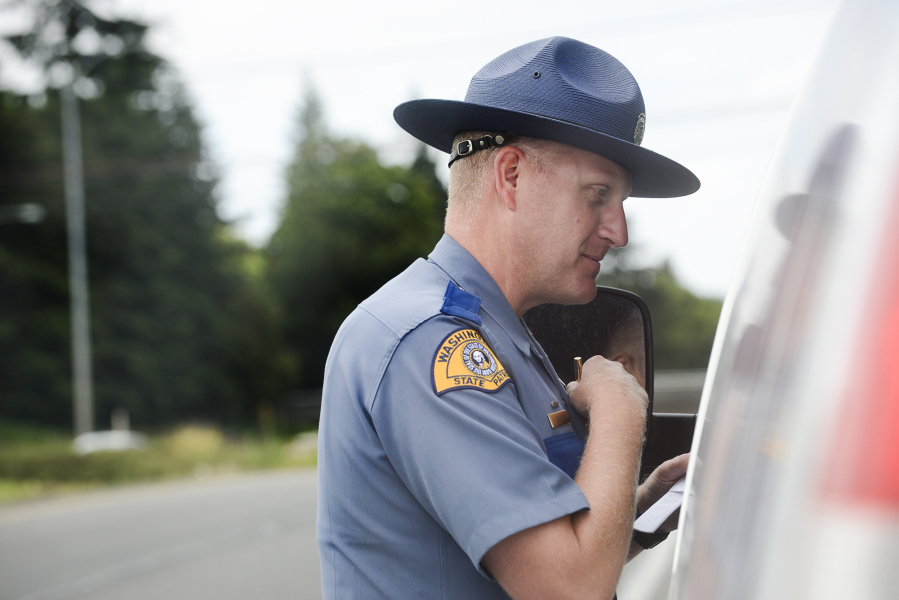 Washington State Patrol Trooper Will Finn talks to a driver he pulled over on suspicion of using a cellphone while driving. The traffic stop was part of a sting on Interstate 5 last month that targeted distracted drivers.