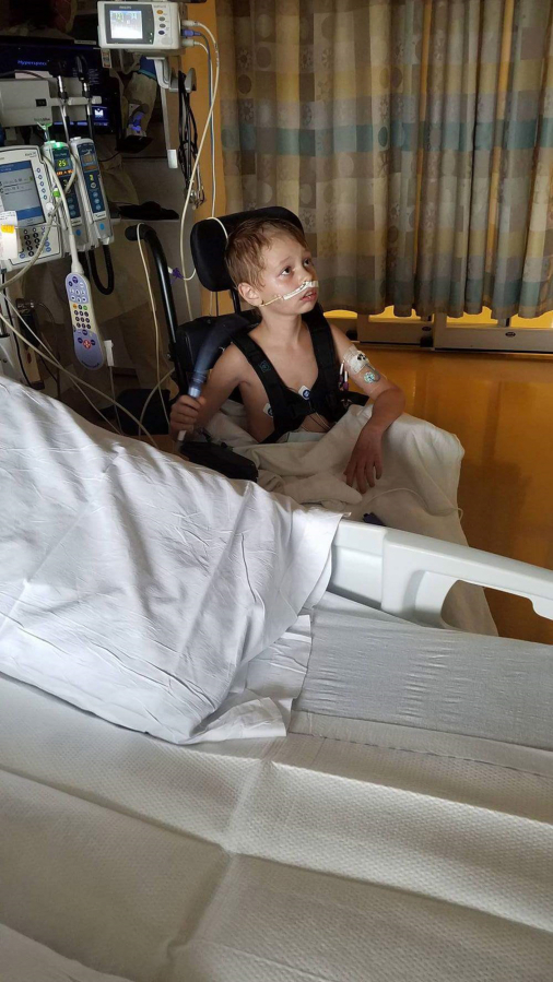 Jackson Gleason, 9, sits up Monday in his hospital room at Randall Children&#039;s Hospital in Portland. The Sherwood, Ore., boy&#039;s condition has improved substantially since he nearly drowned July 21 in a Vancouver pool.