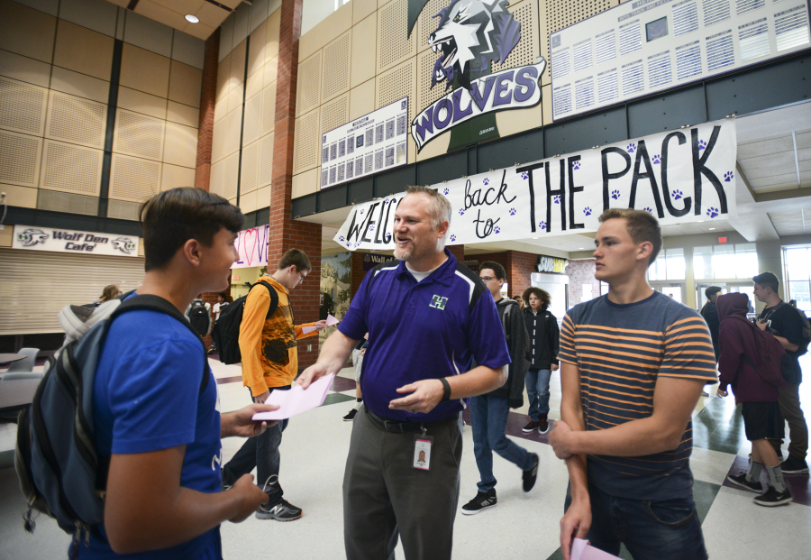 Heritage High School Principal Derek Garrison helps sophomores Anton Tikhonov, left, and Maksim Trukhlinskiy with their schedules Wednesday on the first day of class in Evergreen Public Schools.