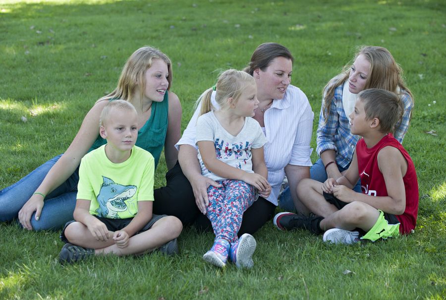 Christie BrownSilva, center, and her children, pictured near Heritage High School, were relieved Monday to hear that Evergreen Public Schools and its union had reached a tentative contract agreement after 14 months of bargaining. BrownSilva&#039;s five children, Toby, 7, from left in shark T-shirt, Jaymie, 13, Paige, 5, Madison, 15, and Kenny, 9, are starting at schools in the district Wednesday.