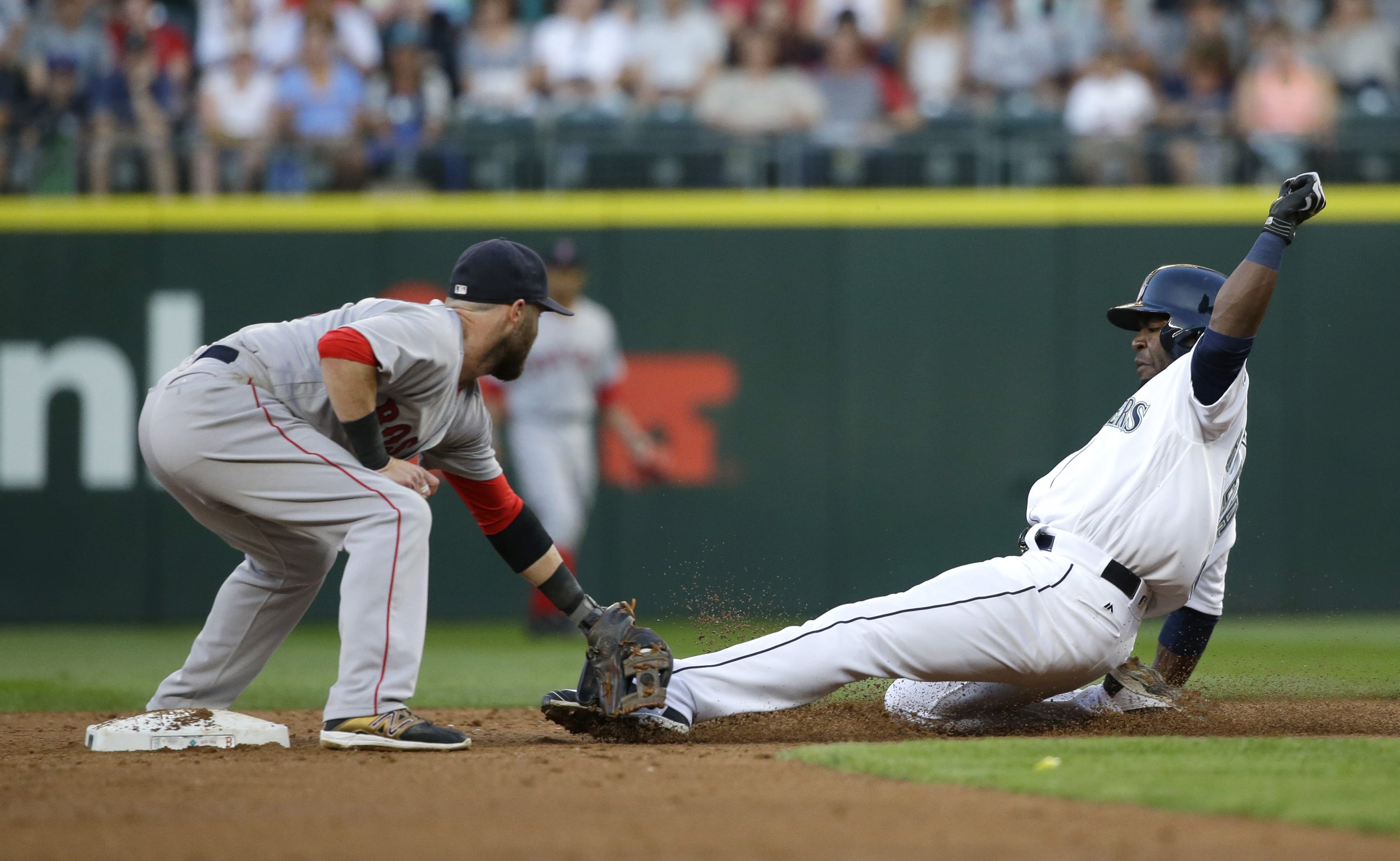 Seattle Mariners' Guillermo Heredia, right, is tagged out by Boston Red Sox second baseman Dustin Pedroia as Heredia tried to steal during the third inning of a baseball game, Thursday, Aug. 4, 2016, in Seattle. (AP Photo/Ted S.