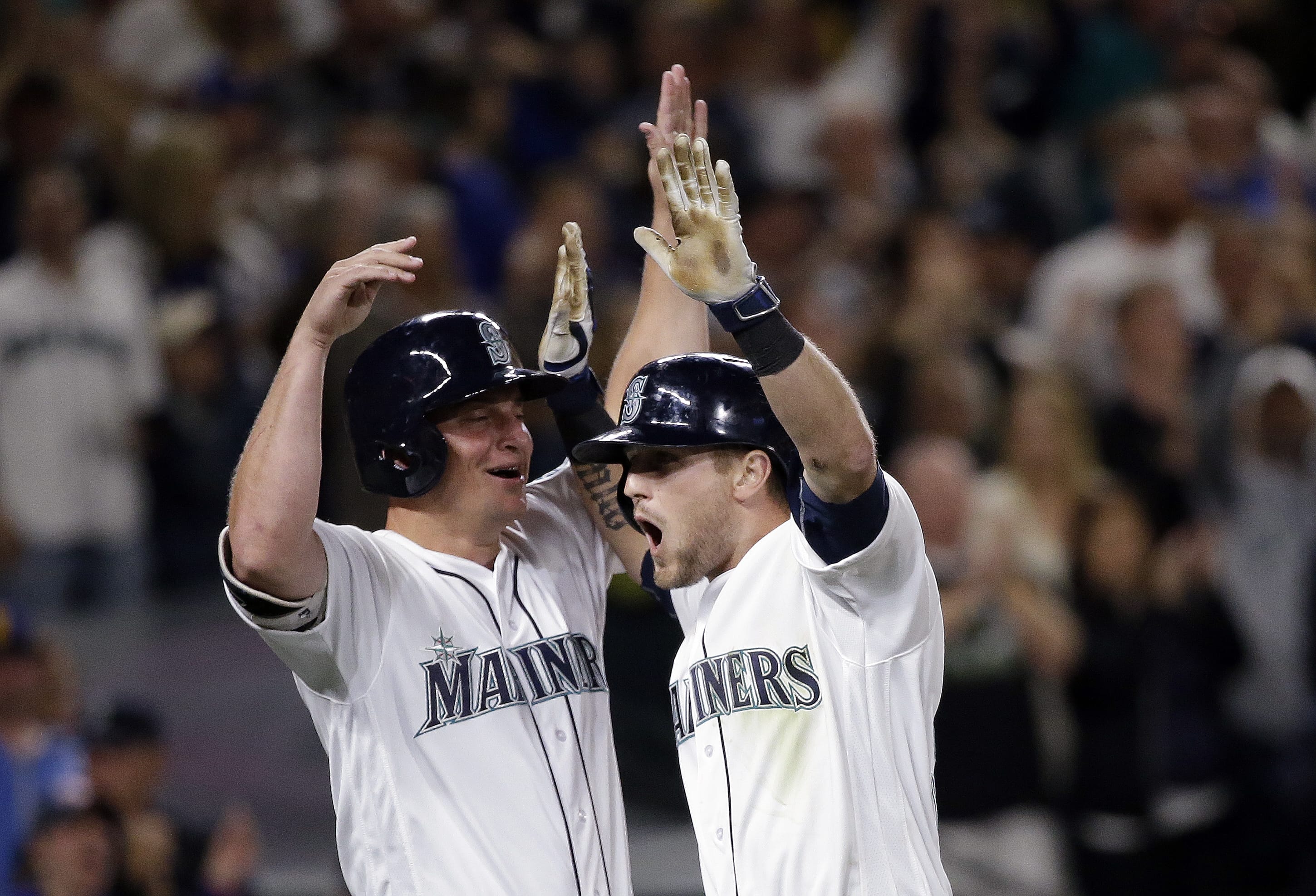Seattle Mariners' Shawn O'Malley, right, is greeted at home by Kyle Seager after O'Malley's three-run home run against the Los Angeles Angels during the seventh inning of a baseball game Saturday, Aug. 6, 2016, in Seattle.