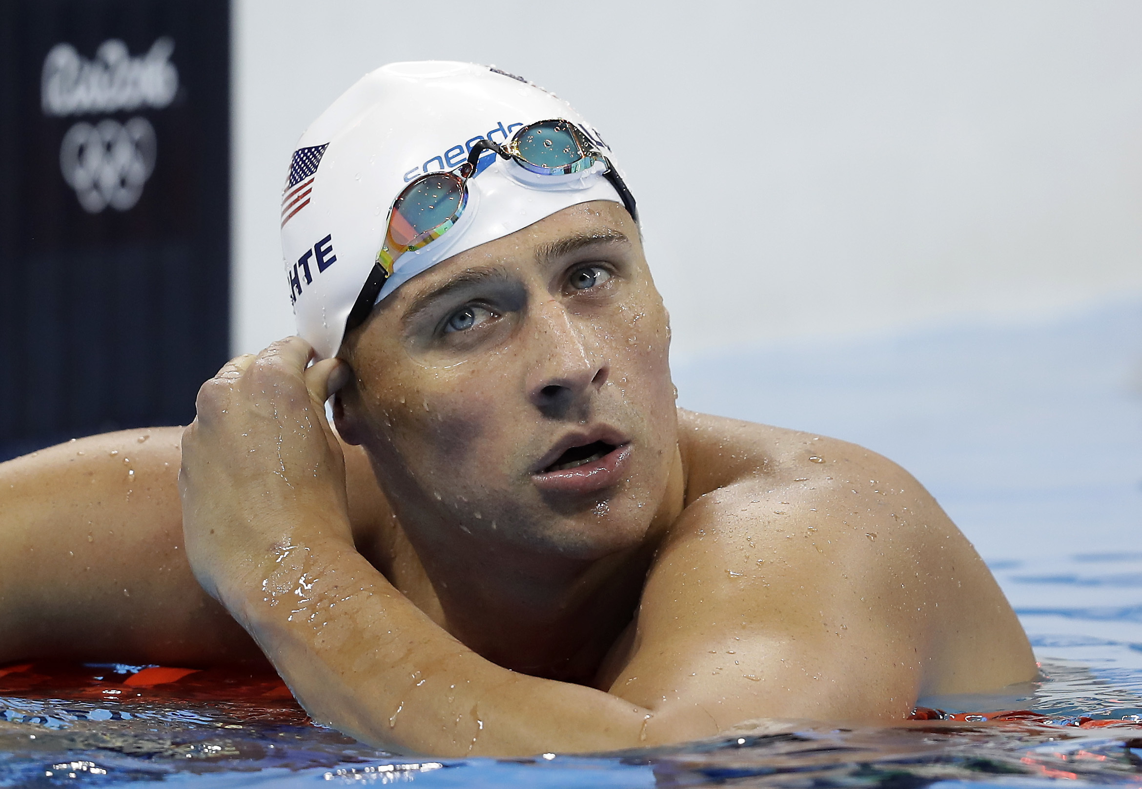 United States' Ryan Lochte checks his time in a men's 4x200-meter freestyle heat during the swimming competitions at the 2016 Summer Olympics, in Rio de Janeiro, Brazil. Lochte and three other American swimmers were robbed at gunpoint early Sunday, Aug. 14, by thieves posing as police officers who stopped their taxi and took their money and belongings, the U.S. Olympic Committee said.