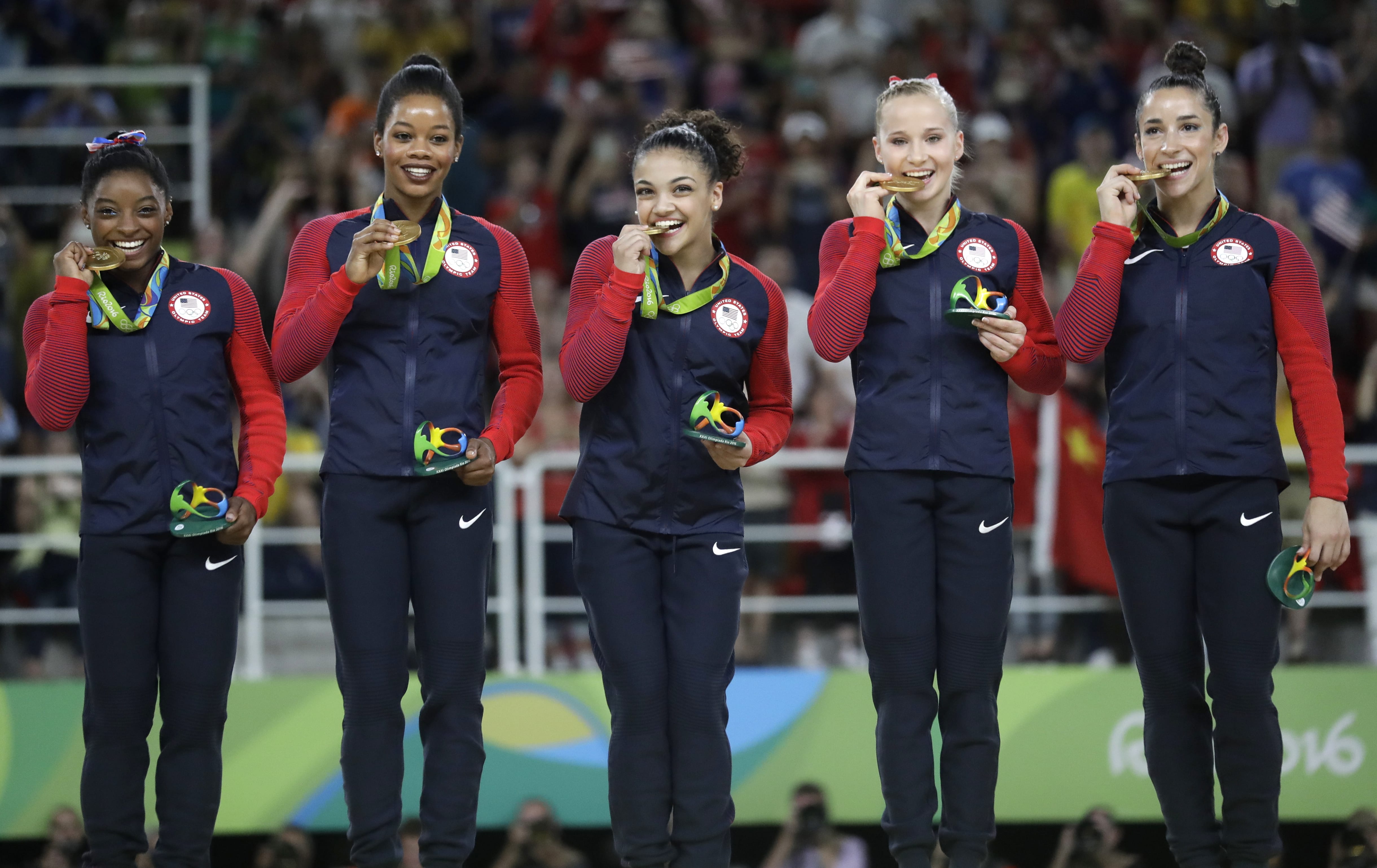U.S. gymnasts, left to right, Simone Biles, Gabrielle Douglas, Lauren Hernandez, Madison Kocian and Aly Raisman hold their gold medals during the medal ceremony for the artistic gymnastics women's team at the 2016 Summer Olympics in Rio de Janeiro, Brazil, Tuesday, Aug. 9, 2016.