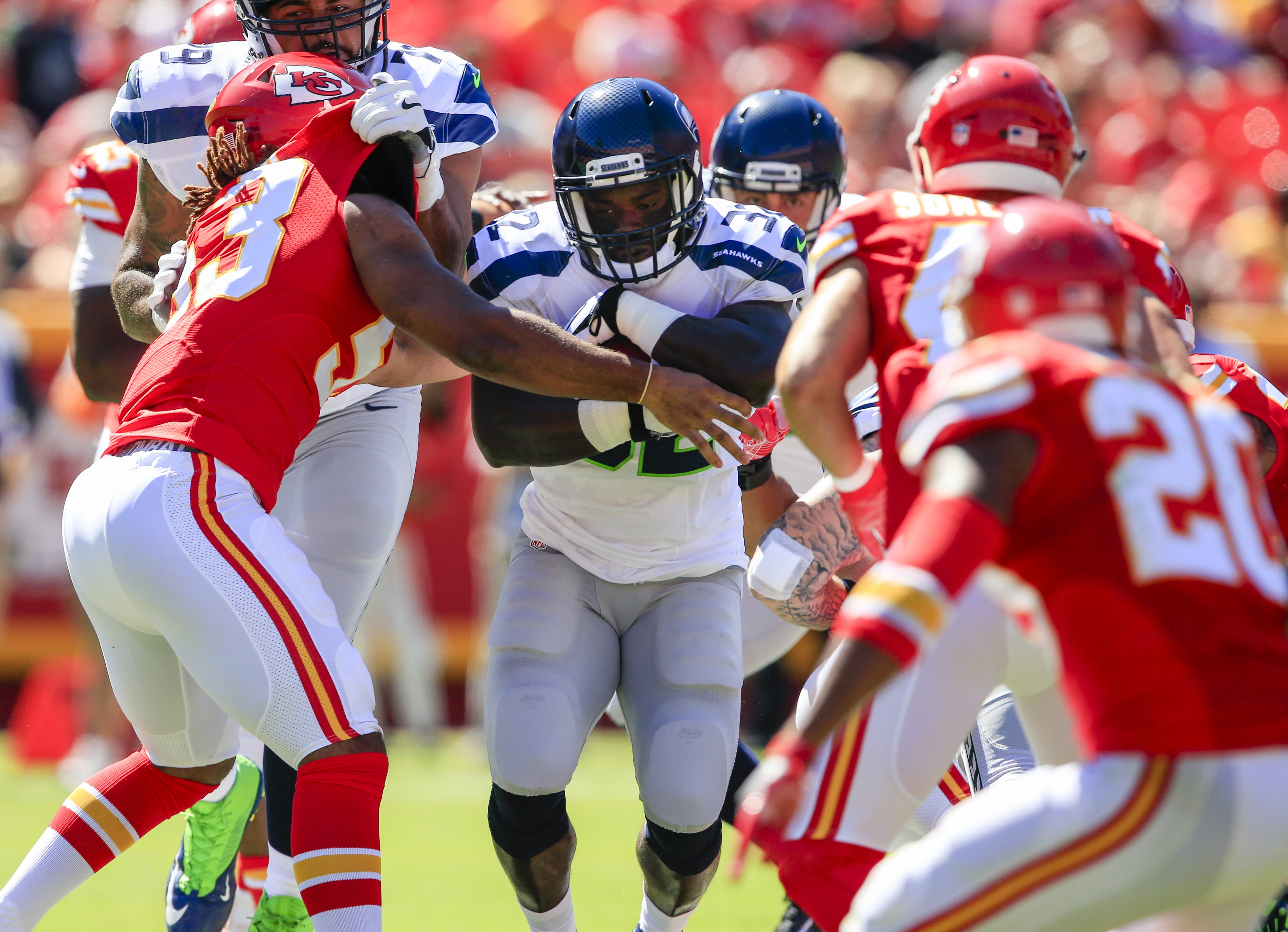 Kansas City Chiefs linebacker Ramik Wilson (53) tries to tackle Seattle Seahawks running back Christine Michael (32) during the first half of an NFL preseason football game in Kansas City, Mo., Saturday, Aug. 13, 2016.