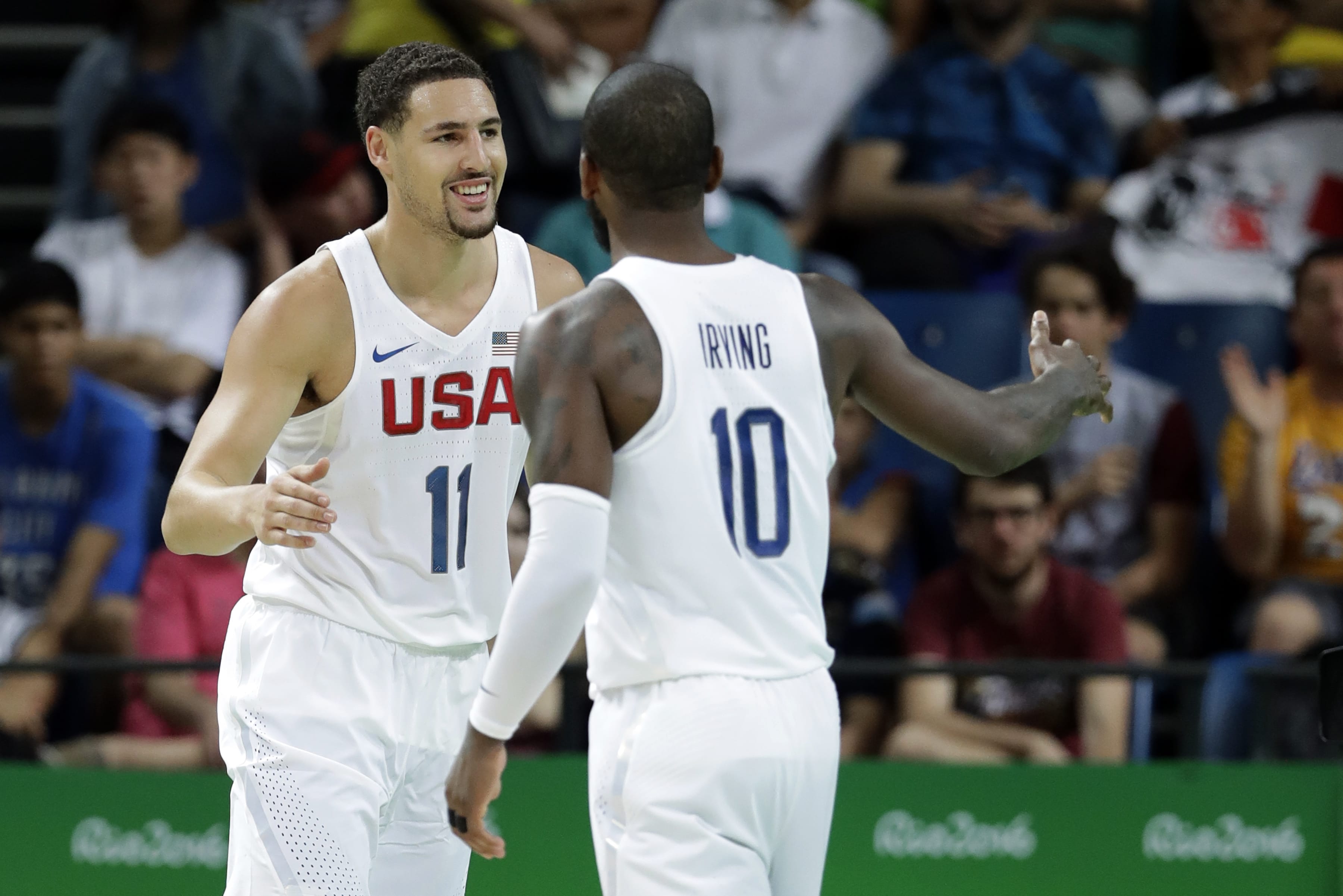 United States' Klay Thompson (11) celebrates with teammate Kyrie Irving (10) after making a basket during a basketball game against France at the 2016 Summer Olympics in Rio de Janeiro, Brazil, Sunday, Aug. 14, 2016.