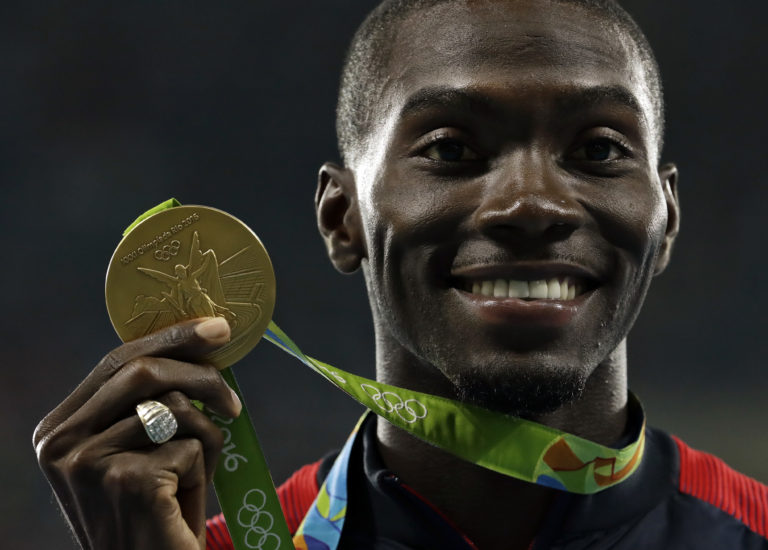 United States' Kerron Clement displays his gold medal for the men's 400-meter hurdles during the athletics competitions of the 2016 Summer Olympics at the Olympic stadium in Rio de Janeiro, Brazil, Thursday, Aug. 18, 2016.