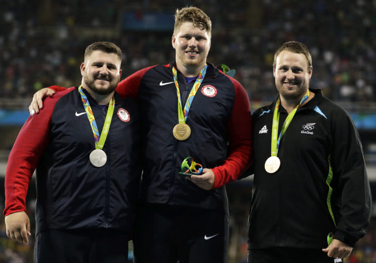 From left, silver medallist United States' Joe Kovacs, compatriot and gold medal winner Ryan Crouser and bronze medallist New Zealand's Tomas celebrate on the podium during the athletics competitions of the 2016 Summer Olympics at the Olympic stadium in Rio de Janeiro, Brazil, Thursday, Aug. 18, 2016.