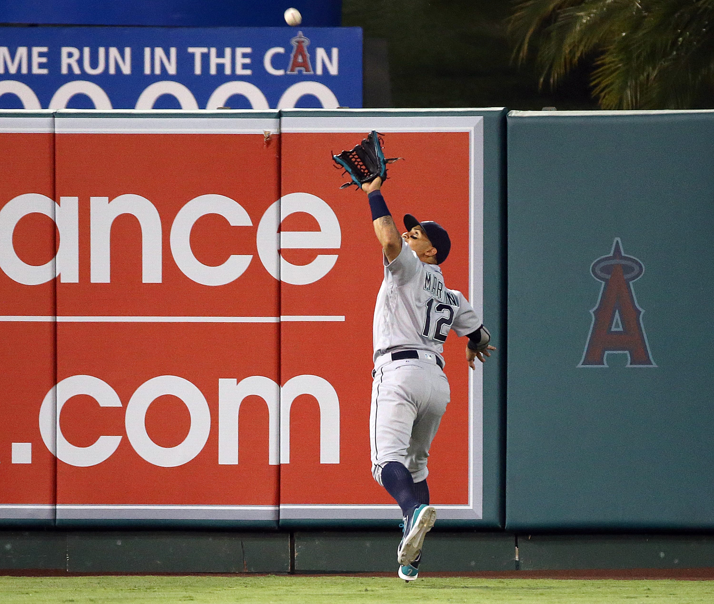 Seattle Mariners center fielder Leonys Martin reaches back to catch a fly ball by Los Angeles Angels' Ji-Man Choi during the second inning of a baseball game in Anaheim, Calif., Thursday, Aug. 18, 2016.