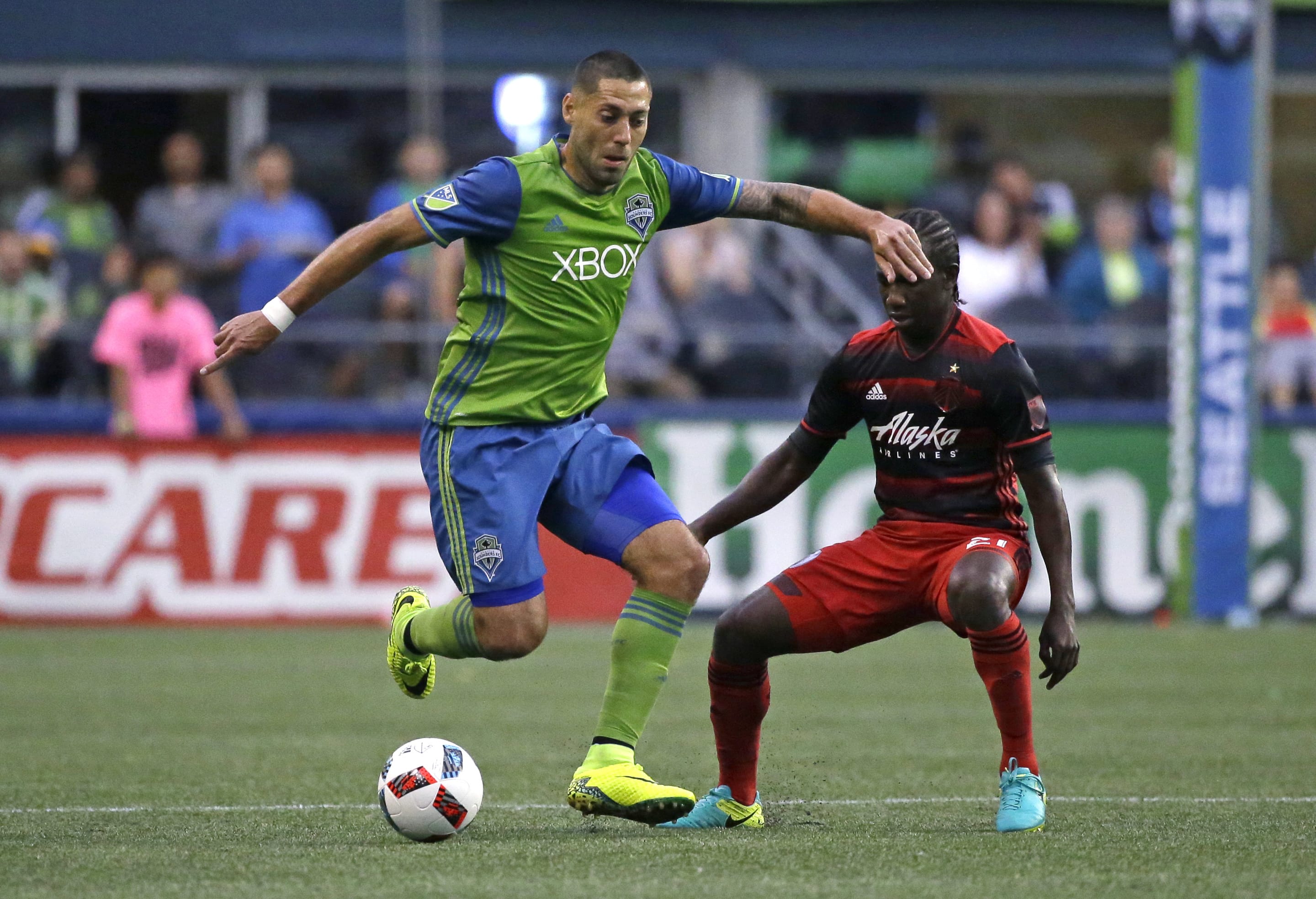 Seattle Sounders forward Clint Dempsey, left, moves the ball around Portland Timbers midfielder Diego Chara, right, in the first half of an MLS soccer match, Sunday, Aug. 21, 2016, in Seattle. (AP Photo/Ted S.