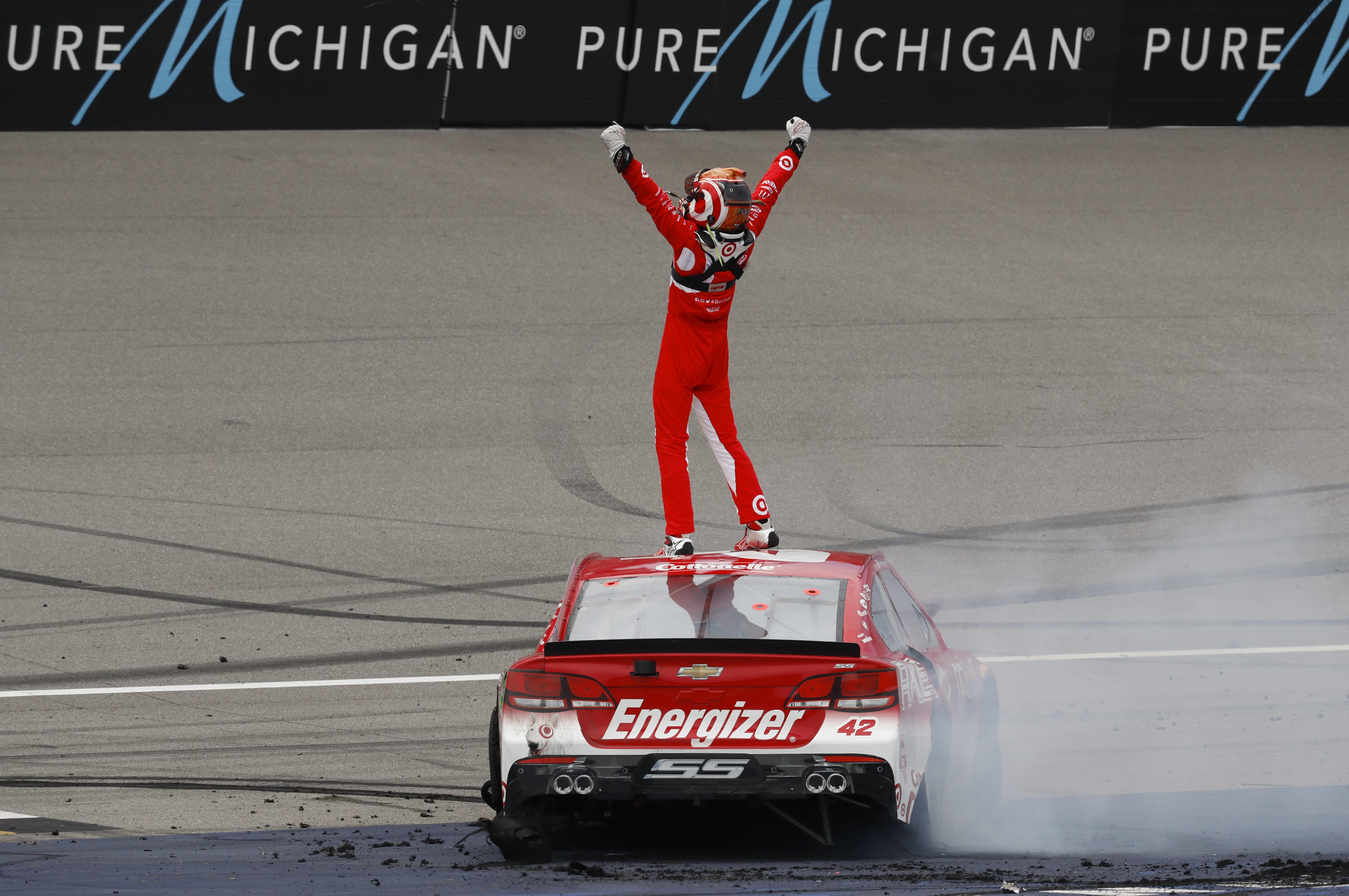 Kyle Larson celebrates winning the NASCAR Sprint Cup Series auto race at Michigan International Speedway, in Brooklyn, Mich., Sunday, Aug. 28, 2016.