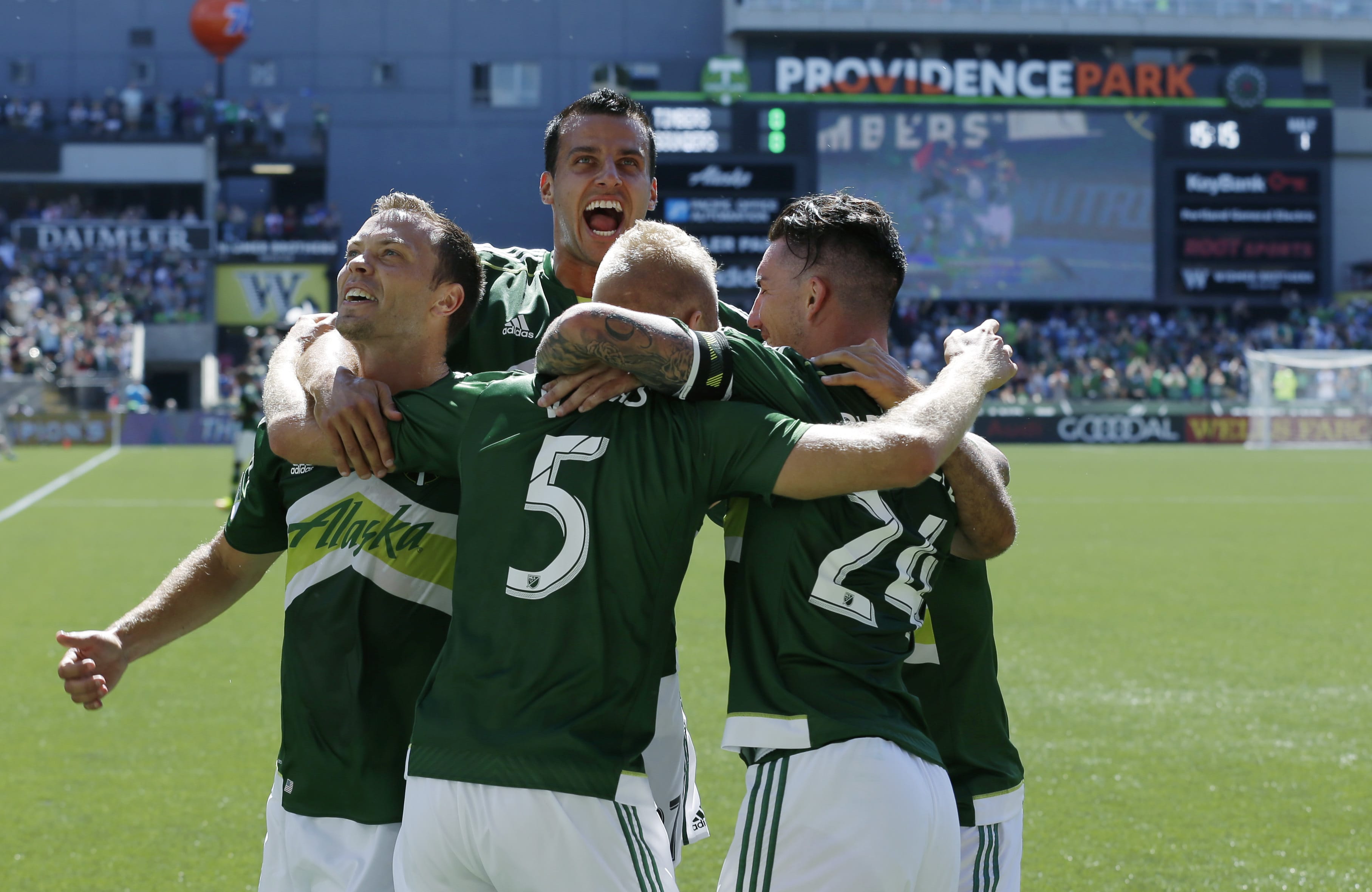 From left, Portland Timbers' Jack Jewsbury, Steven Taylor, Vytas Andriuskevicius (5), and Liam Ridgewell (24) celebrate after Andriuskevicius scored a goal against the Seattle Sounders in the first half of an MLS soccer match, Sunday, Aug. 28, 2016, in Portland, Ore. (AP Photo/Ted S.