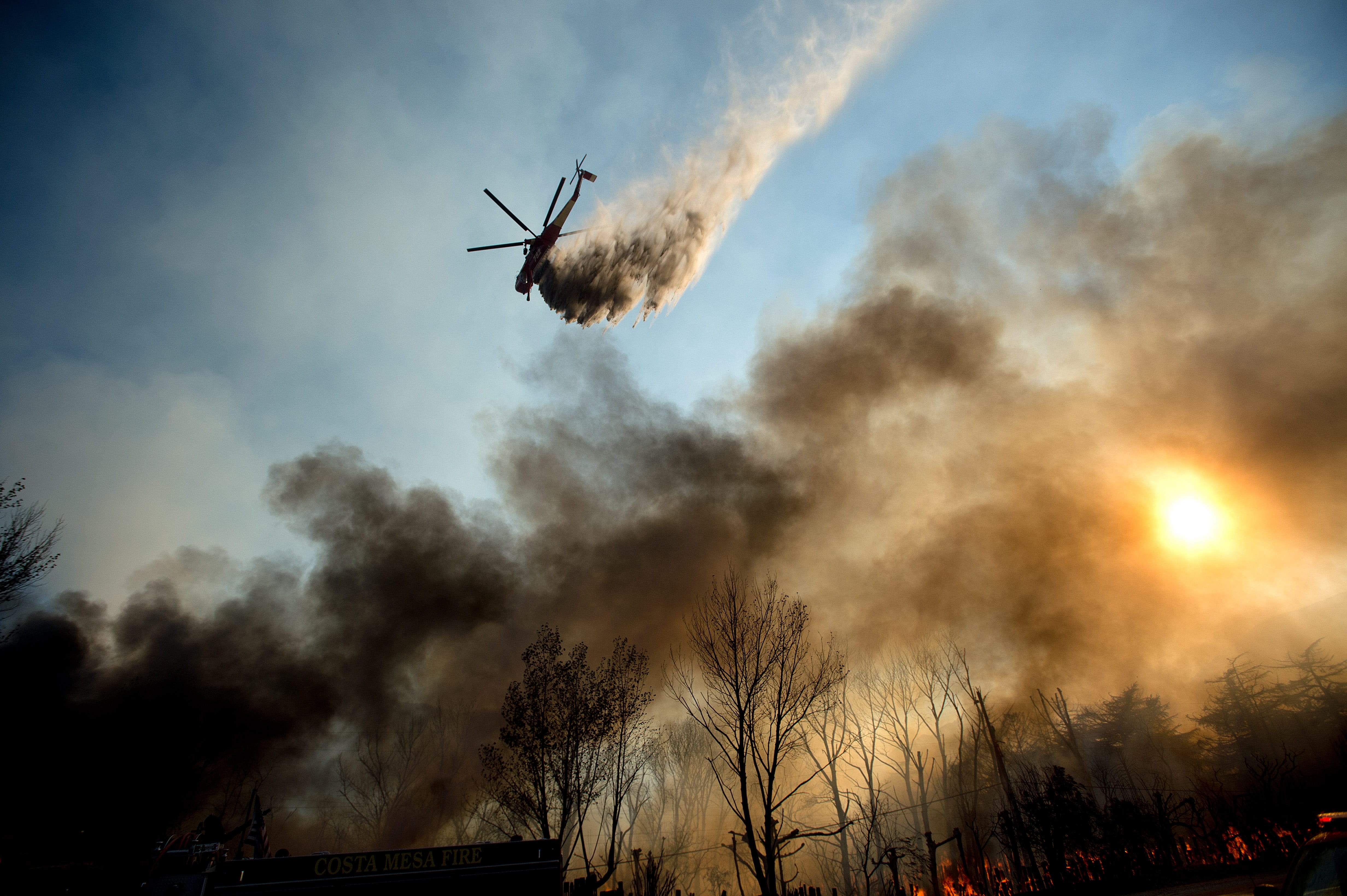 A helicopter drops water on a wildfire as it burns through Keenbrook, Calif., on Wednesday, Aug. 17, 2016. Firefighters had at least established a foothold of control of the blaze the day after it broke out for unknown reasons in the Cajon Pass near Interstate 15, the vital artery between Los Angeles and Las Vegas. Five years of drought have turned the state's wildlands into a tinder box, with eight fires currently burning from Shasta County in the far north to Camp Pendleton just north of San Diego.