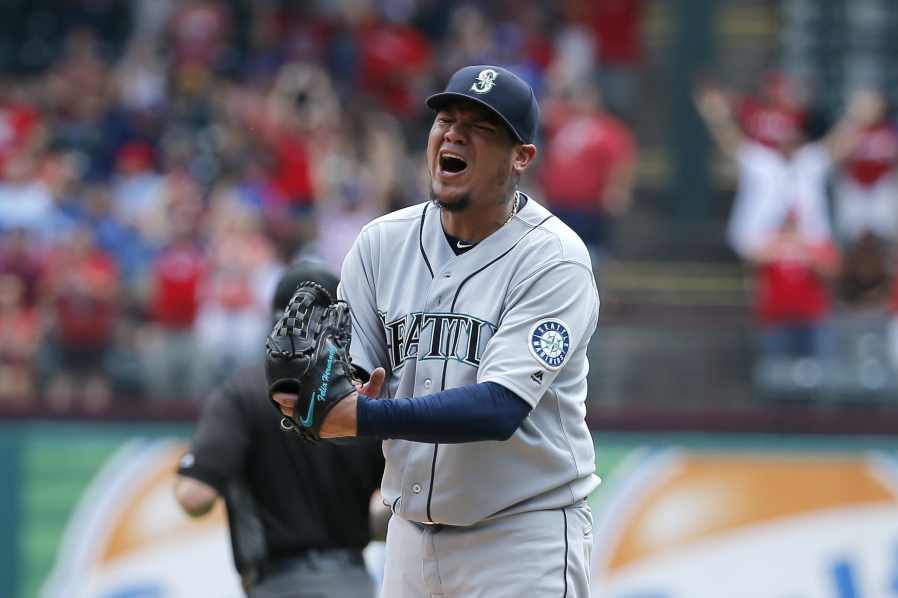 Seattle Mariners starting pitcher Felix Hernandez punches his glove after giving up a grand slam to Texas Rangers&#039; Carlos Gomez in the fourth inning of a baseball game, Wednesday, Aug. 31, 2016, in Arlington, Texas.