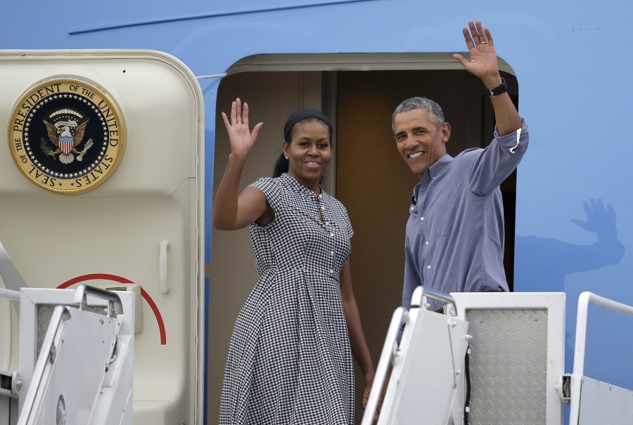 First lady Michelle Obama and President Barack Obama wave Sunday as they board Air Force One at the Cape Cod Coast Guard Station in Bourne, Mass. President Obama and the first family are returning to Washington, D.C., following their vacation on the island of Martha&#039;s Vineyard in Massachusetts.