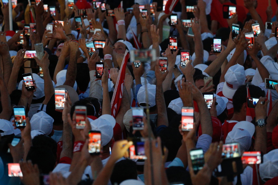 Turkish people use their cellphones to take images Sunday before the speech of President Recep Tayyip Erdogan at the Democracy and Martyrs&#039; Rally in Istanbul.