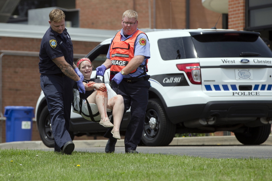 Emergency personnel carry a volunteer with simulated injuries May 25 during a training exercise for an active shooter at Hopewell Elementary School, in West Chester, Ohio.  Violent or disruptive threats are increasing nationwide, according to police, school employees, security consultants and others, blamed sometimes on local students and sometimes on outsiders seeking to cause disruptions or a big emergency response.