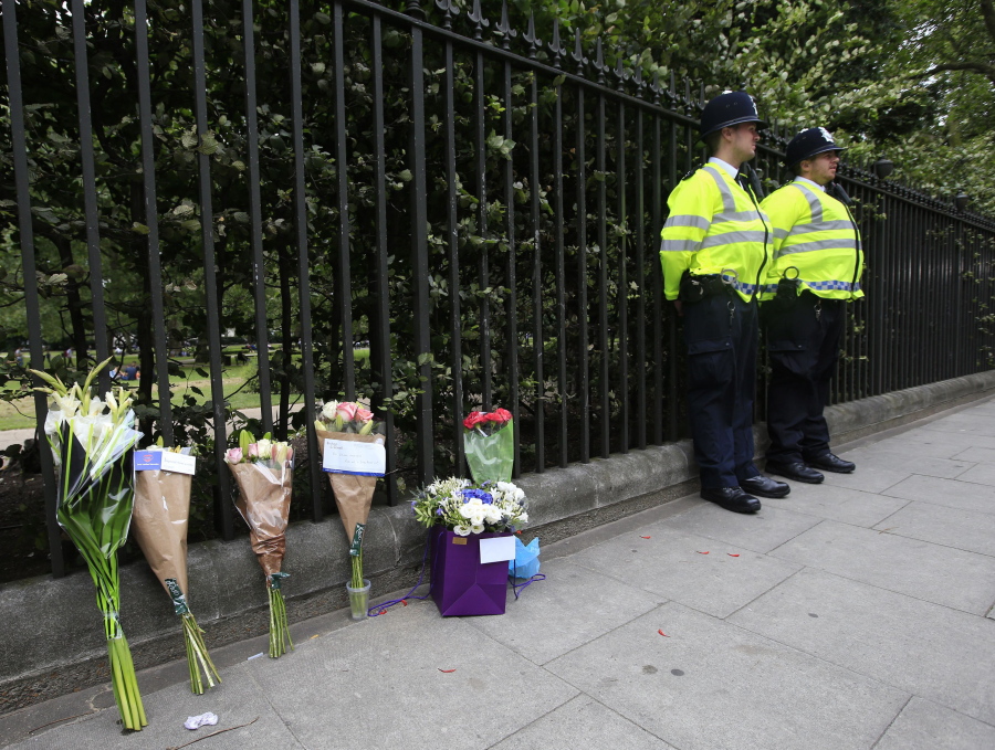 Floral tributes rest against railings Thursday near the scene of a fatal stabbing on Wednesday night in Russell Square, London. London police say they have found no signs of radicalization in a knife attack which killed an American woman and injured five other people in London&#039;s Russell Square.